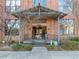 Building 55 entrance with brick facade, metal awning, and a concrete walkway at 500 N Duke St # 55-103, Durham, NC 27701