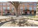 Exterior shot of a brick building, showing an outdoor seating area with a metal table set at 500 N Duke St # 55-103, Durham, NC 27701