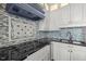 Close-up of gourmet kitchen featuring stainless appliances, and eye-catching mosaic backsplash at 500 N Duke St # 55-103, Durham, NC 27701