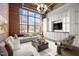 Bright living room featuring exposed brick, large windows, and custom built-ins at 500 N Duke St # 55-103, Durham, NC 27701