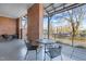 Community patio area with seating, brick support columns and treed street view at 500 N Duke St # 55-103, Durham, NC 27701
