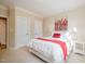 Serene bedroom with natural light, plush carpet, and a cozy bed with decorative pillows and linens at 5000 Sears Farm Rd, Cary, NC 27519