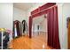 Open dressing room with wooden floors and a red curtain for privacy at 5000 Sears Farm Rd, Cary, NC 27519