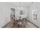 Bright dining room with hardwood floors, a stylish chandelier, and wainscoting at 509 Arbor Crest Rd, Holly Springs, NC 27540