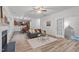 Cozy living room with hardwood floors, a ceiling fan, stylish furniture, and seamless flow to the kitchen at 509 Arbor Crest Rd, Holly Springs, NC 27540