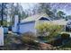 Charming home exterior featuring light siding, a chimney, and well-maintained landscaping at 5108 Gable Ridge Dr, Durham, NC 27713