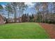 Expansive backyard with lush lawn and mature trees at 5204 Winter Holly Ct, Raleigh, NC 27606