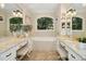 Luxurious bathroom boasts dual vanities, soaking tub, and plenty of natural light at 5204 Winter Holly Ct, Raleigh, NC 27606