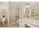 Bright bathroom with glass enclosed shower, neutral color palette, and vanity area at 5204 Winter Holly Ct, Raleigh, NC 27606