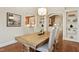 Bright dining room with hardwood floors, stylish light fixture, and elegant archways to other living spaces at 5204 Winter Holly Ct, Raleigh, NC 27606