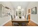 Dining room featuring a chandelier, hardwood floors, a bay window, and stylish seating at 5204 Winter Holly Ct, Raleigh, NC 27606