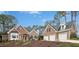 Charming brick home with a well-manicured front yard and a spacious three-car garage at 5204 Winter Holly Ct, Raleigh, NC 27606