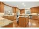 Spacious kitchen with wood cabinets, stainless steel appliances, granite countertops, and a central island at 5204 Winter Holly Ct, Raleigh, NC 27606