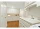 Large laundry room with many storage cabinets, sink, and counter space for folding at 5204 Winter Holly Ct, Raleigh, NC 27606