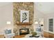 Cozy living room features stone fireplace, hardwood floors, and comfortable seating at 5204 Winter Holly Ct, Raleigh, NC 27606