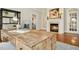 Comfortable workspace featuring a rustic wooden desk, fireplace, and hardwood flooring at 5204 Winter Holly Ct, Raleigh, NC 27606