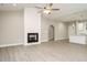 A bright living room with wood-look flooring, a fireplace, and an open concept kitchen at 531 Perth Rd, Sanford, NC 27332