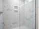 Close up of the glass-enclosed shower with marble tiling and a built-in shower niche at 531 Perth Rd, Sanford, NC 27332