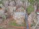 Aerial view of home with mature trees and yard, showcasing its private location in wooded, natural setting at 5512 Spring Bluffs Ln, Raleigh, NC 27606