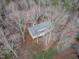 Aerial view of a house nestled among trees, showcasing its secluded location and expansive lot at 5512 Spring Bluffs Ln, Raleigh, NC 27606