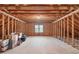 Expansive unfinished attic space with wooden beams and natural light from window at 5512 Spring Bluffs Ln, Raleigh, NC 27606