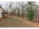 Expansive backyard featuring mature trees providing shade and natural beauty to the property at 5512 Spring Bluffs Ln, Raleigh, NC 27606