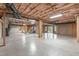 Large unfinished basement with exposed ceiling, concrete floor, and natural light from a window at 5512 Spring Bluffs Ln, Raleigh, NC 27606