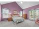 Airy bedroom with vaulted ceiling, a ceiling fan, two windows, and a door to the deck at 5512 Spring Bluffs Ln, Raleigh, NC 27606