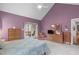 Bright bedroom with vaulted ceiling, balcony access, and hardwood dressers at 5512 Spring Bluffs Ln, Raleigh, NC 27606