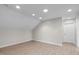 Bright bonus room with neutral walls, recessed lighting, and attractive wood-look floors at 5512 Spring Bluffs Ln, Raleigh, NC 27606
