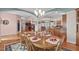Bright dining room featuring hardwood floors and ornate decorations connecting to the kitchen and living room at 5512 Spring Bluffs Ln, Raleigh, NC 27606