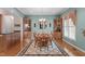 Elegant dining room with hardwood floors, a chandelier, and custom-built display cabinets at 5512 Spring Bluffs Ln, Raleigh, NC 27606