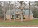 Charming brick home with a lush front lawn and mature trees providing shade and character at 5512 Spring Bluffs Ln, Raleigh, NC 27606