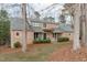Brick two-story home with a welcoming front porch, landscaped shrubs, and a well-maintained lawn at 5512 Spring Bluffs Ln, Raleigh, NC 27606