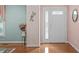 Inviting foyer with hardwood floors, decorative wall accents, and a view of the front door at 5512 Spring Bluffs Ln, Raleigh, NC 27606