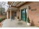 Welcoming front entrance with rocking chairs, a well-maintained brick facade, and decorative greenery at 5512 Spring Bluffs Ln, Raleigh, NC 27606