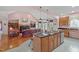Open-concept kitchen and living area with a large island, granite countertops, and a cozy fireplace at 5512 Spring Bluffs Ln, Raleigh, NC 27606
