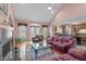 Open-concept living room with fireplace, vaulted ceiling, access to deck, and flow into kitchen at 5512 Spring Bluffs Ln, Raleigh, NC 27606