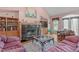 Cozy living room featuring hardwood floors, a fireplace with decorative mantle, and built-in shelving at 5512 Spring Bluffs Ln, Raleigh, NC 27606