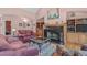 Inviting living room with fireplace, built-in shelving, hardwood floors, and plenty of seating at 5512 Spring Bluffs Ln, Raleigh, NC 27606