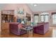 Spacious living room with vaulted ceiling, fireplace, hardwood floors, and large windows for natural light at 5512 Spring Bluffs Ln, Raleigh, NC 27606