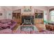 Warm living room with hardwood floors, fireplace, built-in shelving, and comfortable seating at 5512 Spring Bluffs Ln, Raleigh, NC 27606