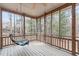 Charming screened-in porch with a swing, perfect for enjoying the outdoors in comfort at 5512 Spring Bluffs Ln, Raleigh, NC 27606