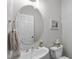 Charming powder room featuring an oval mirror, pedestal sink, and delightful decorative accents at 5512 Spring Bluffs Ln, Raleigh, NC 27606