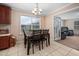 Eat-in kitchen with wood table and seating adjacent to large living space at 6001 Rock Bottom Rd, Oxford, NC 27565