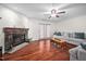 Inviting living room featuring a stone fireplace, hardwood floors, and comfortable seating at 6001 Rock Bottom Rd, Oxford, NC 27565