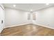 Bedroom featuring wood floors, white walls, recessed lights and two windows at 6065 Merion Cir, Sanford, NC 27332
