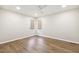 Bright bedroom featuring wood floors, white walls, recessed lights and two windows at 6065 Merion Cir, Sanford, NC 27332