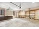 View of unfinished garage space with peg board, cabinetry, and overhead door at 6065 Merion Cir, Sanford, NC 27332
