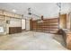 View of garage space featuring door to exterior, shelving, and overhead door at 6065 Merion Cir, Sanford, NC 27332